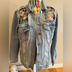 Revamped distressed look jean jacket. Floral lace inert details.